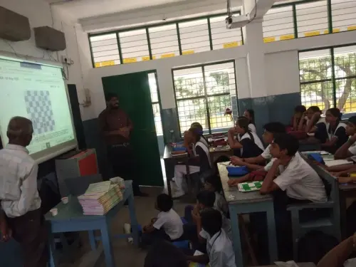 student-playing-chess-with-teacher